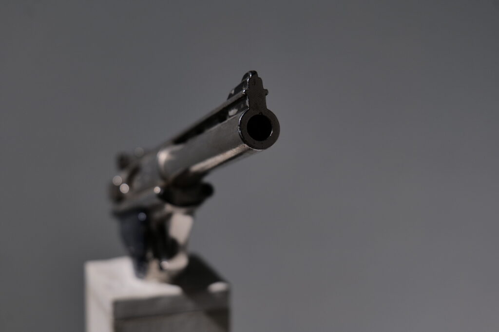 Detail of a revolver on a plinth