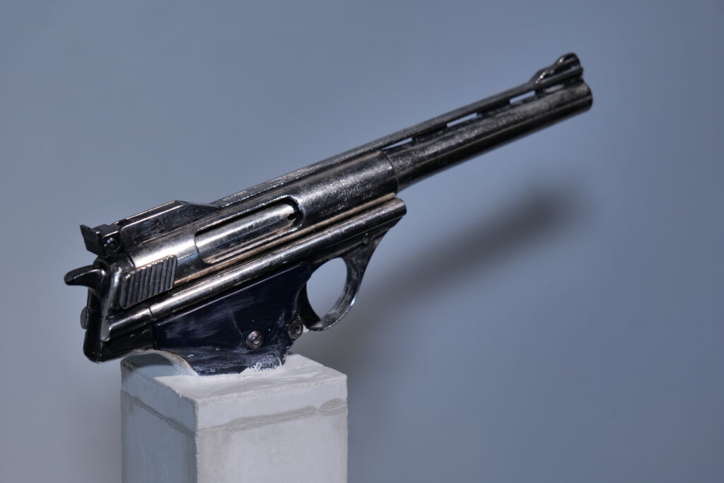 A revolver presented on a white plinth