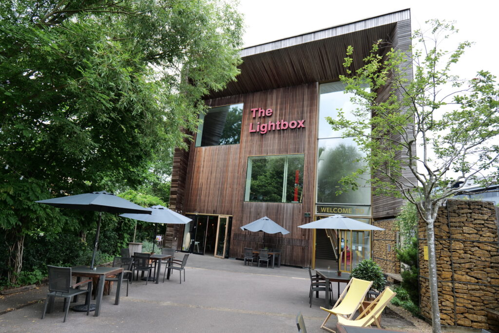 Exterior of The Lightbox, with the terrace and cafe tables